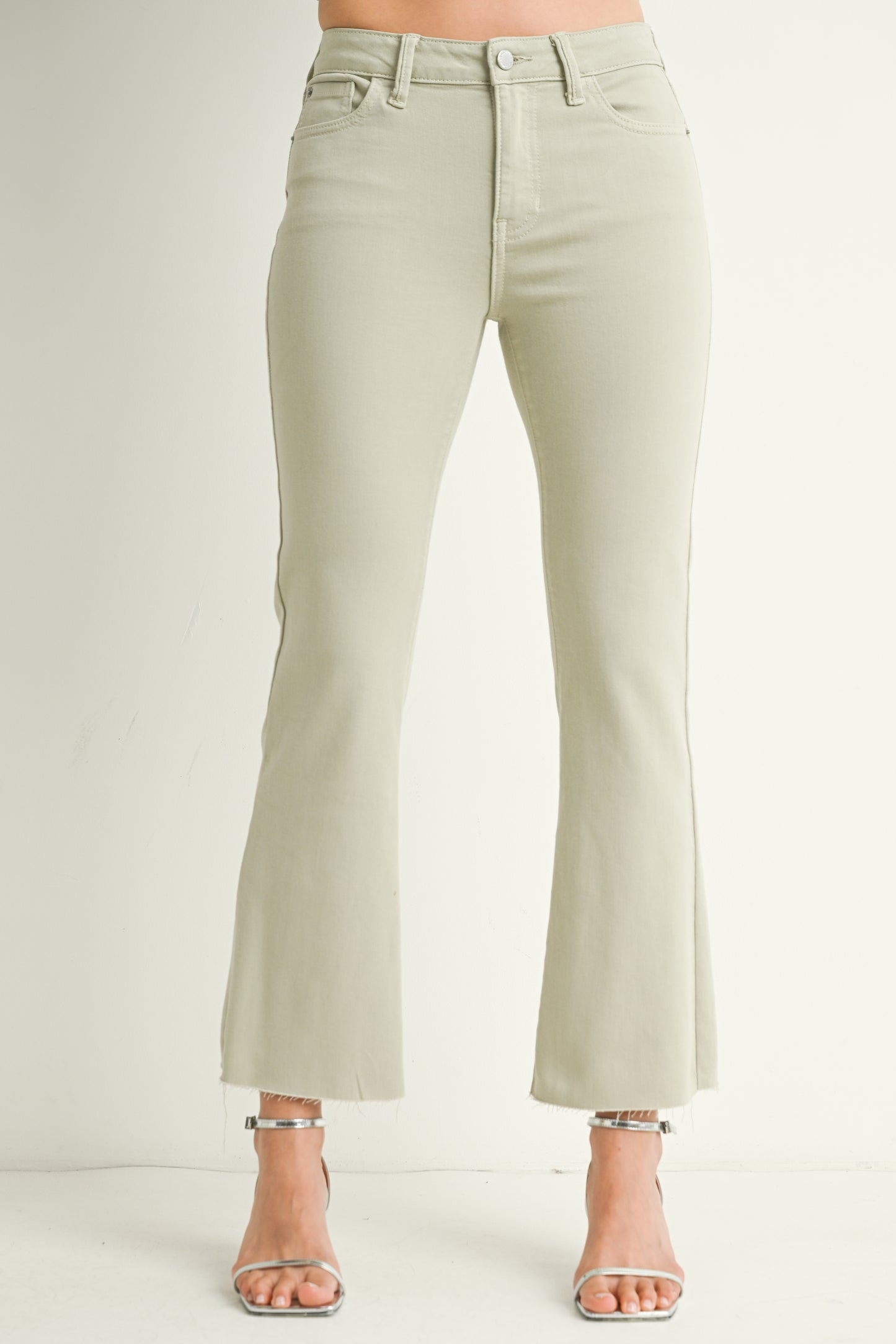 Light green jeans worn by a person on a white background
