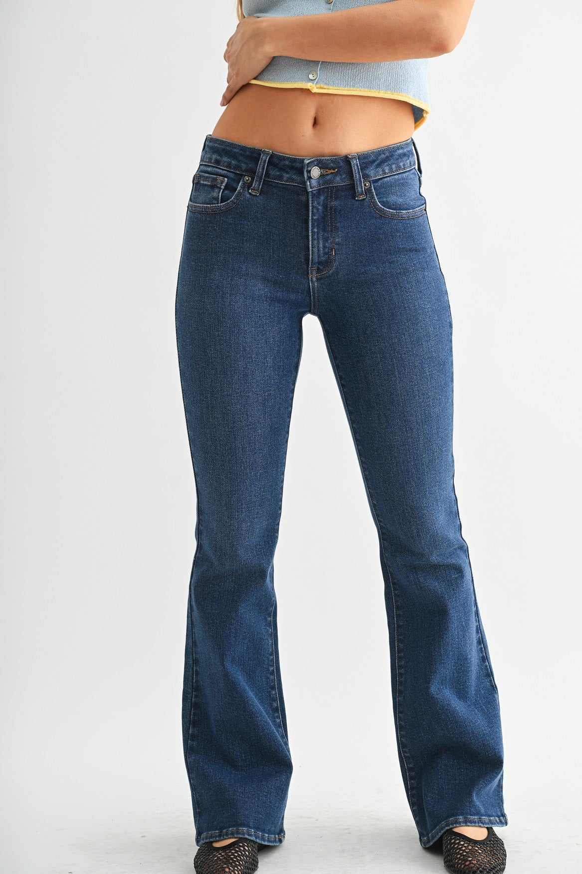 Blue jeans worn by a person on a white background
