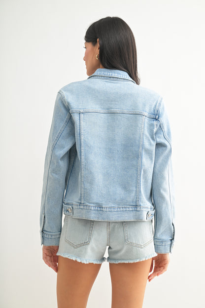 Person wearing a light blue denim jacket and shorts on a white background