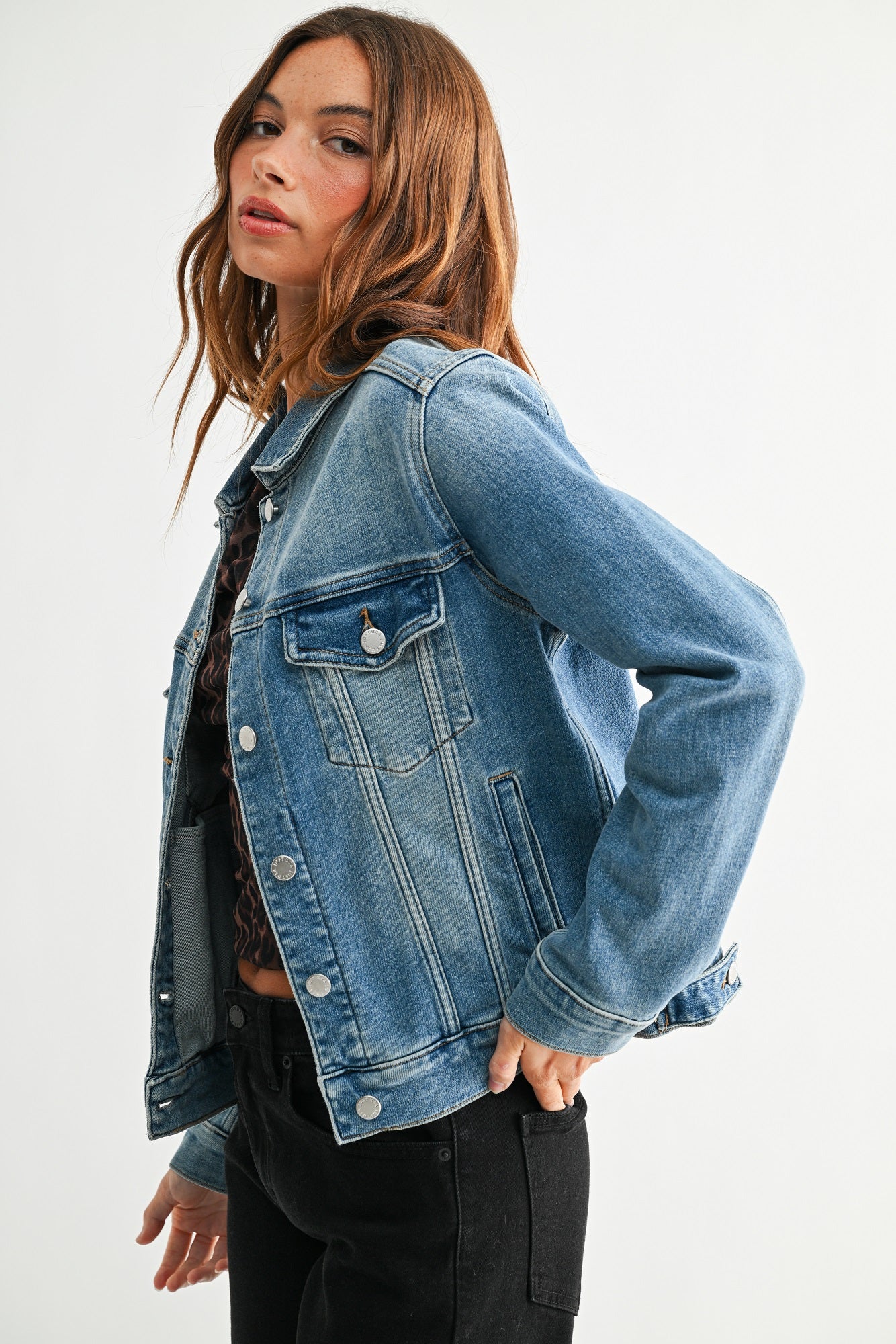 Woman wearing a blue denim jacket on a white background