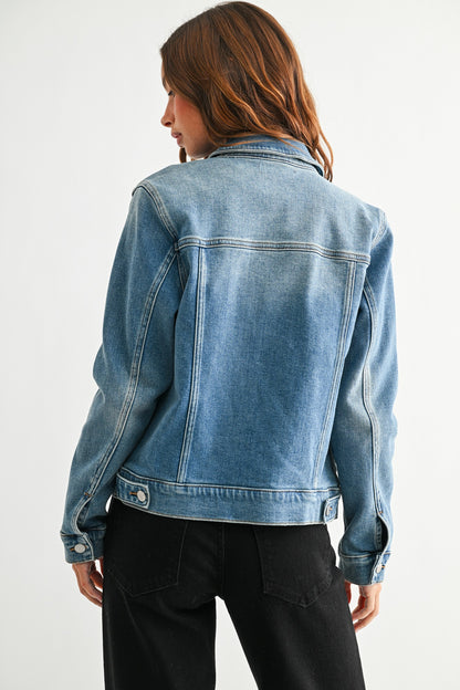 Person wearing a blue denim jacket on a white background