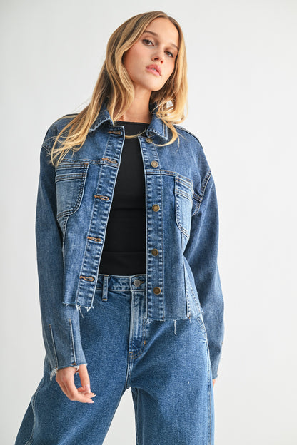 Woman wearing a denim jacket and jeans on a white background