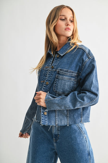 Woman wearing a blue denim jacket and jeans on a white background