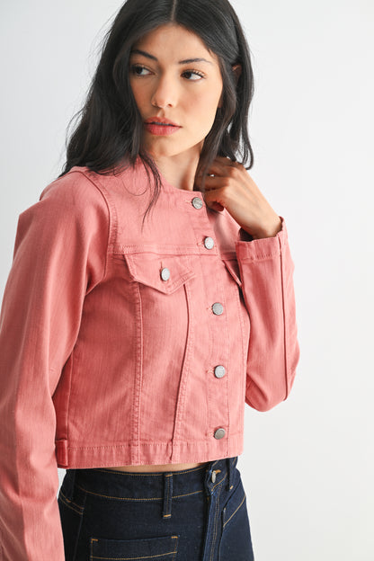 Woman wearing a pink denim jacket on a white background