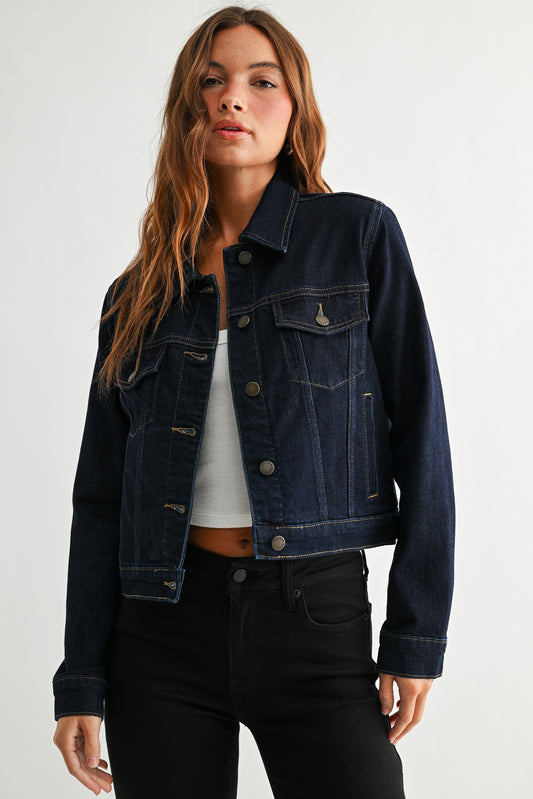 Woman wearing a dark denim jacket on a white background