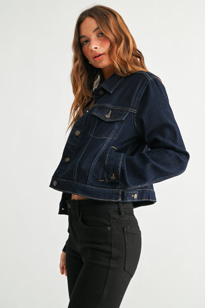 Woman wearing a dark blue denim jacket on a white background