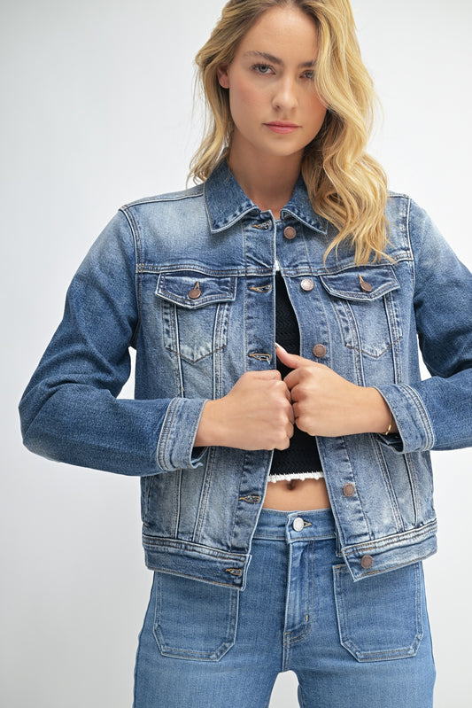 Woman wearing a blue denim jacket and jeans on a white background