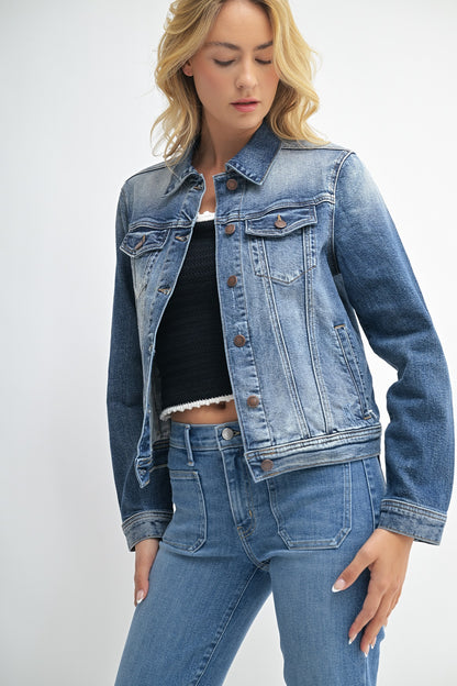 Woman wearing a blue denim jacket and jeans on a white background