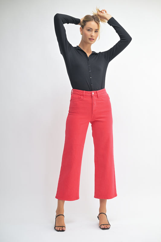 Woman wearing a black shirt and red pants on a white background