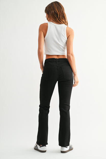 Person wearing black pants and a white top on a white background