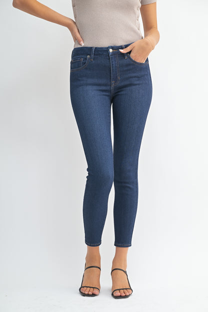 Person wearing blue jeans on a white background