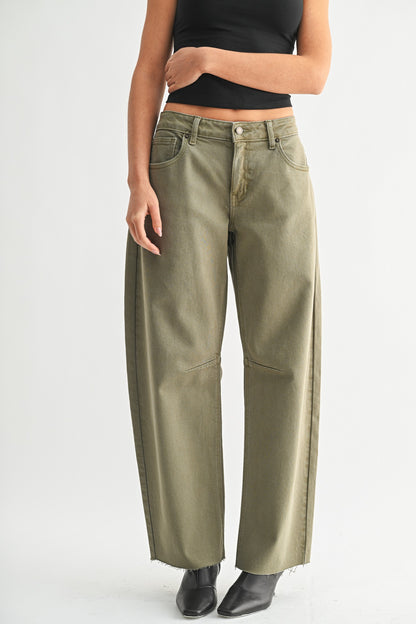 Person wearing olive green pants on a white background