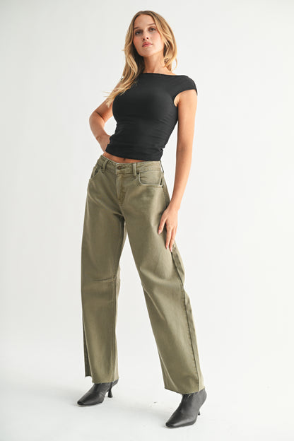 Woman wearing a black t-shirt and olive green pants on a white background