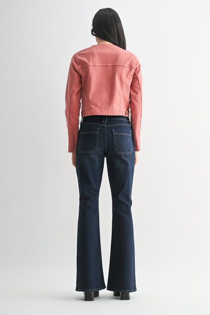 Person wearing a pink jacket and blue jeans on a white background